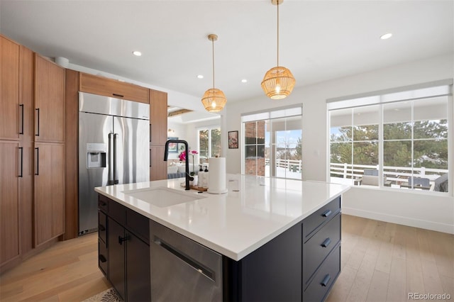 7079 S Locust Pl, Centennial, CO 80112 - kitchen with recessed lighting, a sink, light wood-style flooring, and appliances with stainless steel finishes