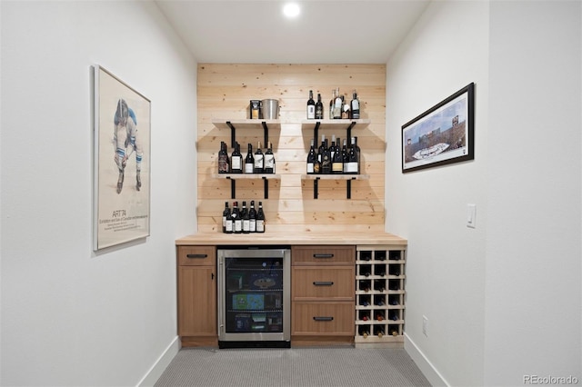 7079 S Locust Pl, Centennial, CO 80112 - bar with beverage cooler, baseboards, wooden walls, and a bar