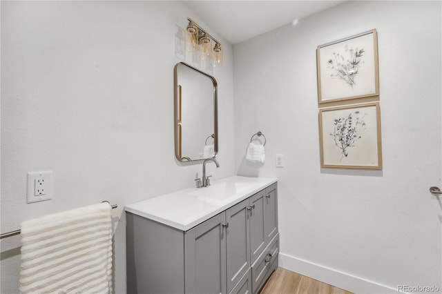 7079 S Locust Pl, Centennial, CO 80112 - bathroom featuring wood finished floors, baseboards, and vanity
