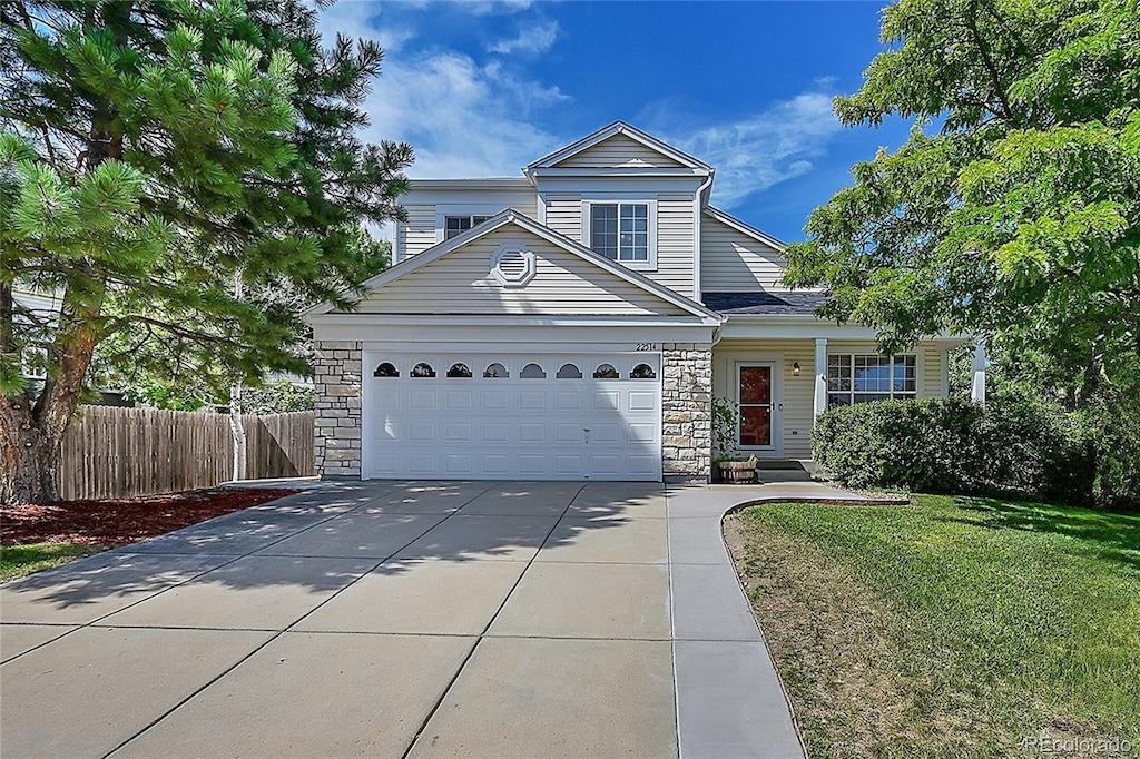 view of front property with a garage and a front lawn