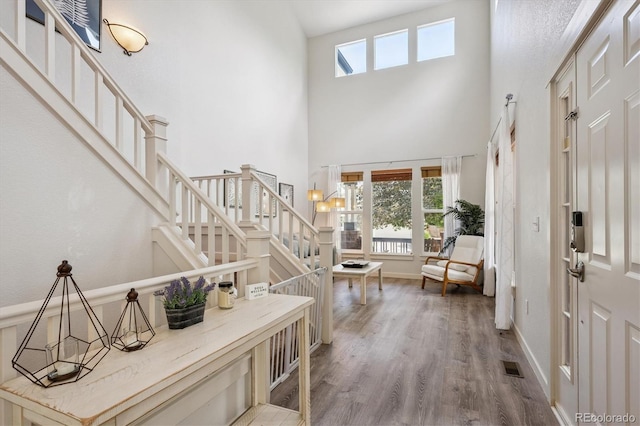 10955 Dearborne Dr, Parker, CO 80134 - entrance foyer featuring a high ceiling, plenty of natural light, stairway, and wood finished floors