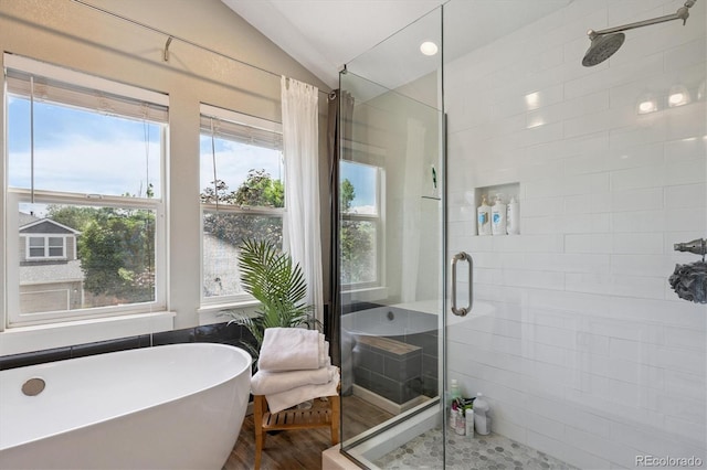 10955 Dearborne Dr, Parker, CO 80134 - full bathroom with a shower stall, a soaking tub, lofted ceiling, and wood finished floors