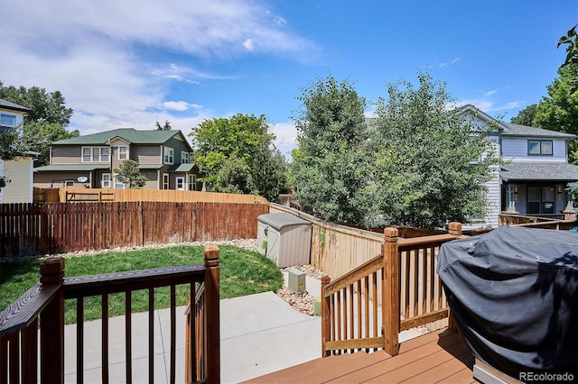 10955 Dearborne Dr, Parker, CO 80134 - wooden deck featuring a fenced backyard, area for grilling, a storage unit, and a residential view