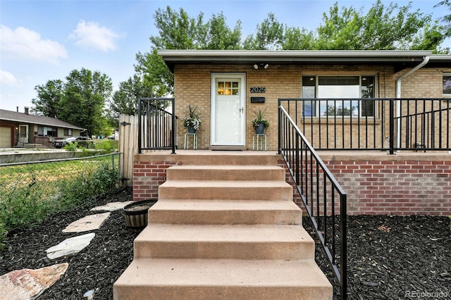 2025 Otis St, Edgewater, CO 80214 - single story home featuring brick siding and a porch