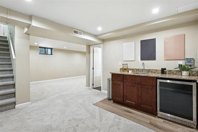 2025 Otis St, Edgewater, CO 80214 - indoor wet bar featuring wine cooler, stairs, light carpet, and recessed lighting