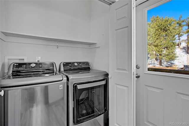 laundry area with washing machine and clothes dryer