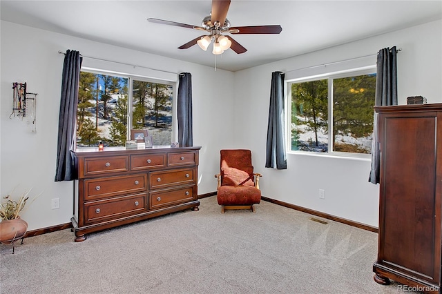 sitting room featuring ceiling fan, carpet floors, and plenty of natural light