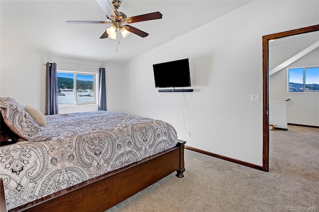 carpeted bedroom featuring lofted ceiling and ceiling fan