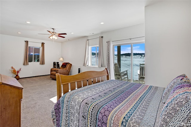 carpeted bedroom with access to outside, a water view, and ceiling fan