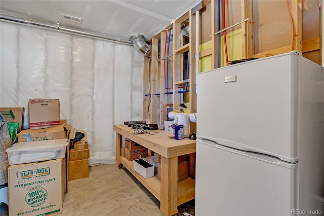 basement with white fridge