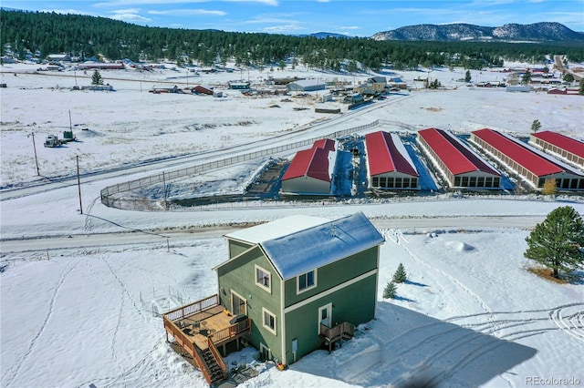 snowy aerial view featuring a mountain view