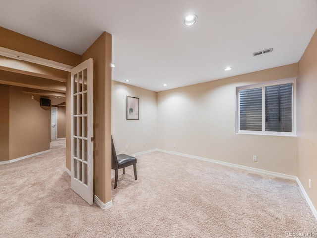 basement featuring light colored carpet