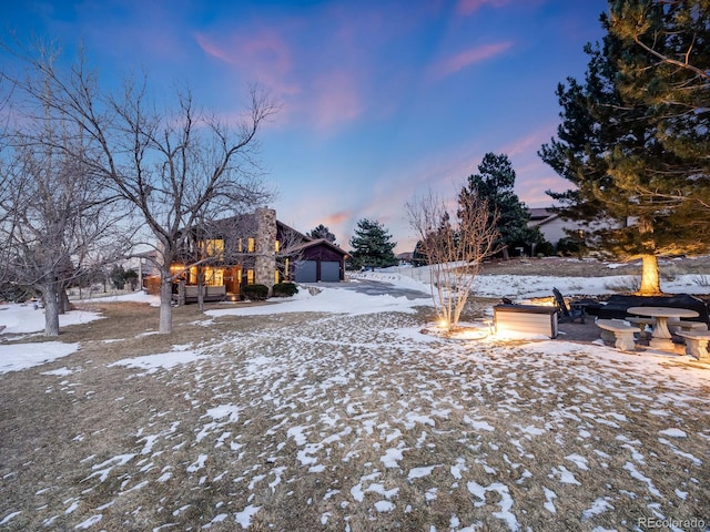 yard covered in snow featuring a fire pit