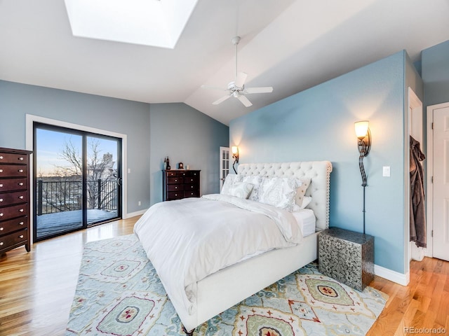 bedroom featuring baseboards, a ceiling fan, lofted ceiling with skylight, access to outside, and light wood-style floors