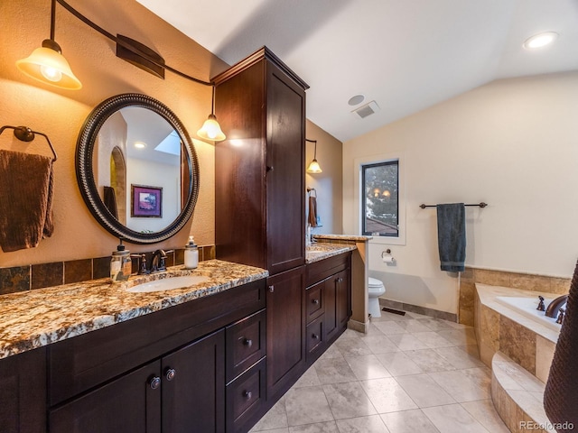 bathroom with lofted ceiling, toilet, tiled bath, tile patterned flooring, and vanity