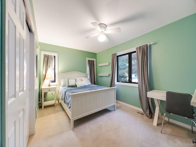 carpeted bedroom with ceiling fan, baseboards, and visible vents