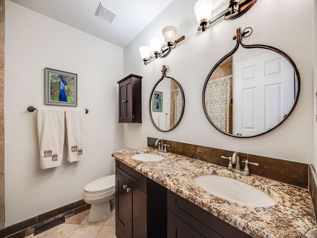 full bathroom featuring toilet, visible vents, a sink, and double vanity