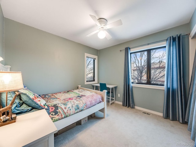 bedroom featuring baseboards, multiple windows, visible vents, and light colored carpet