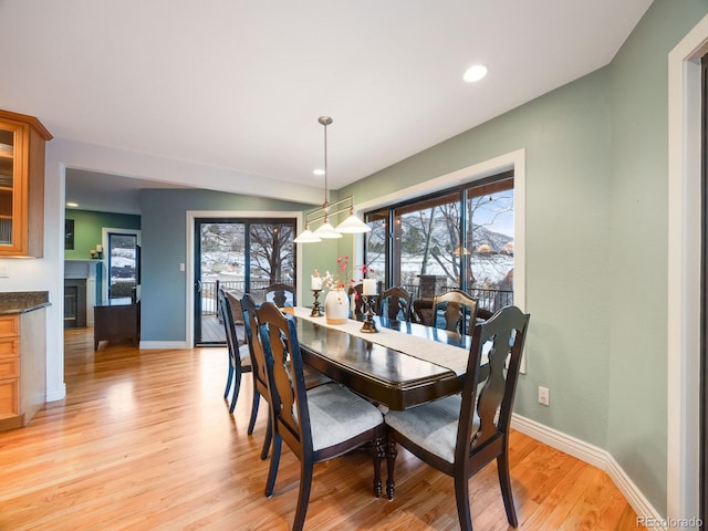 dining area featuring baseboards, recessed lighting, and light wood-type flooring