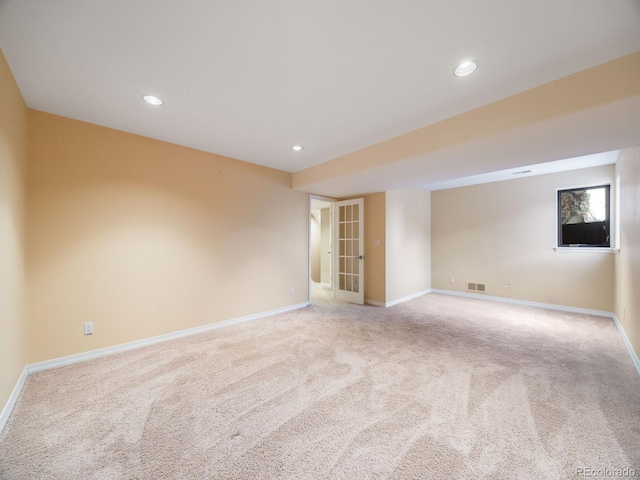 carpeted spare room featuring visible vents, baseboards, and recessed lighting