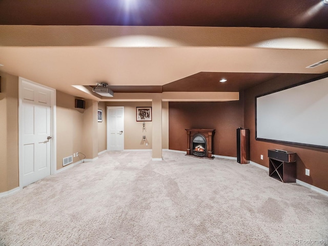 carpeted cinema room featuring baseboards and visible vents