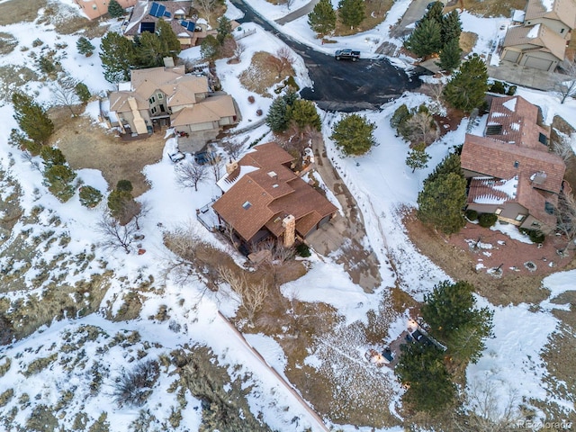 snowy aerial view with a residential view