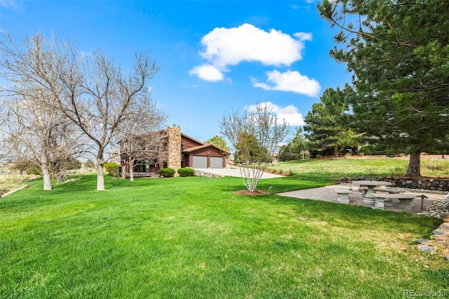 10895 Pheasant Run, Littleton, CO 80125 - view of grassy yard with a garage