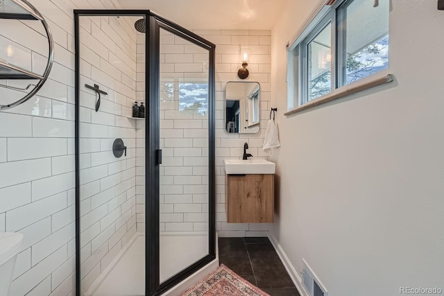 bathroom featuring vanity, tile patterned floors, and walk in shower