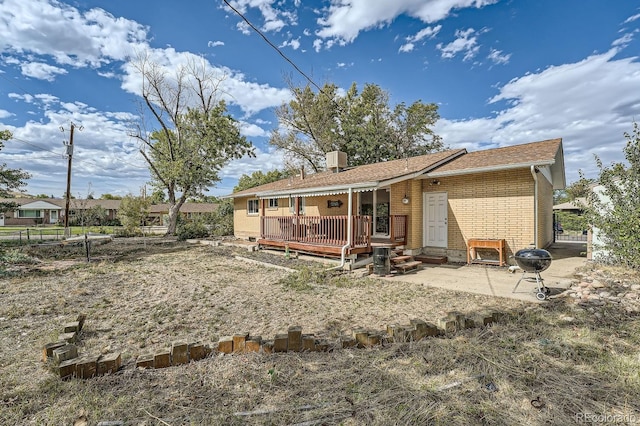 back of property with a patio