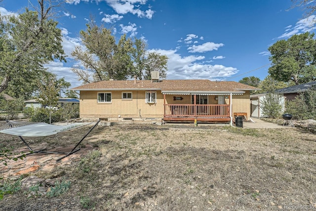 back of house featuring a wooden deck and central AC