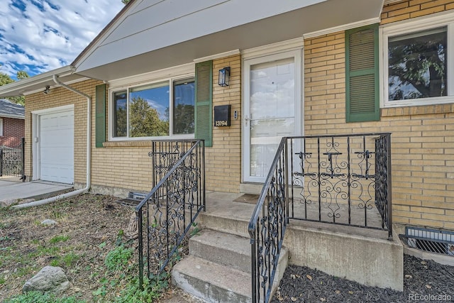 doorway to property with a garage