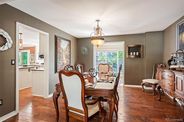 dining space with dark hardwood / wood-style flooring