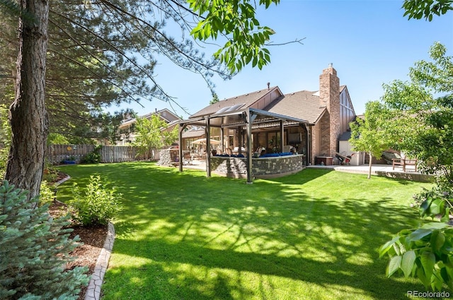 rear view of property with a yard and a patio