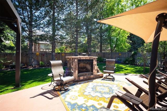 view of patio / terrace featuring an outdoor stone fireplace