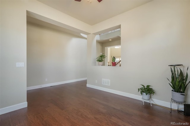 unfurnished room featuring dark hardwood / wood-style floors and ceiling fan