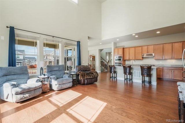 living room with sink and light wood-type flooring