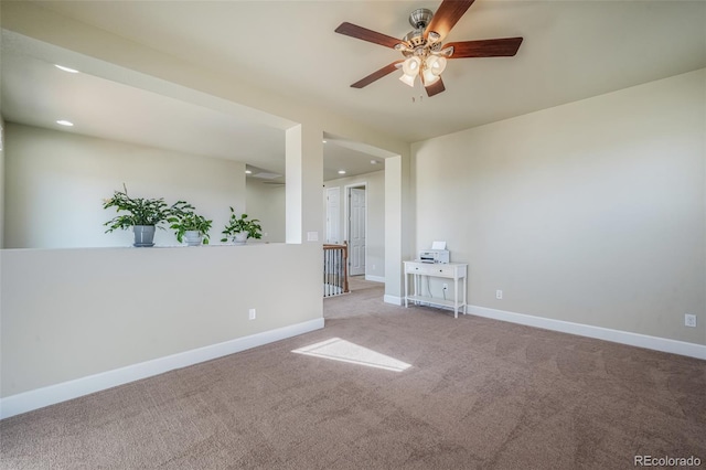 spare room with carpet floors and ceiling fan