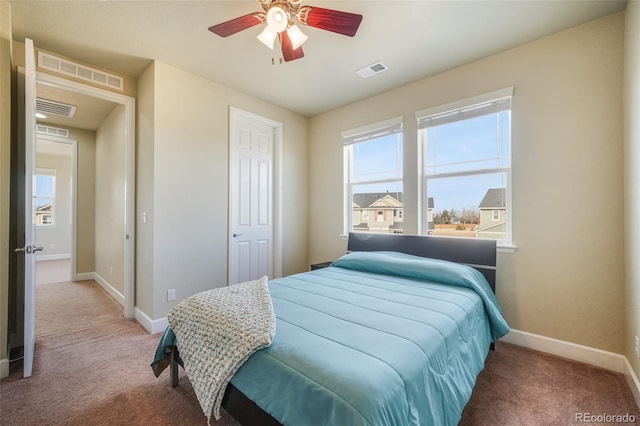 carpeted bedroom with ceiling fan and a closet