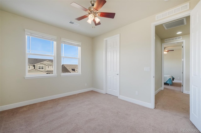 unfurnished bedroom with light carpet and ceiling fan