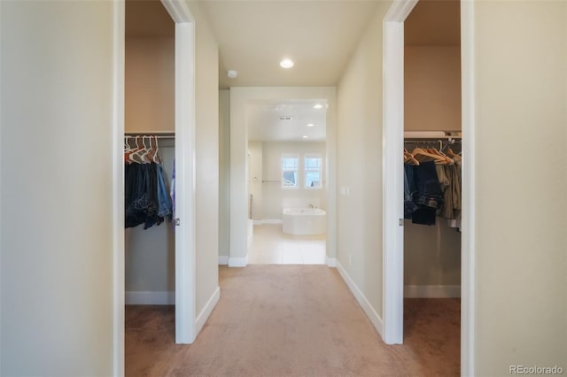 hallway with light colored carpet