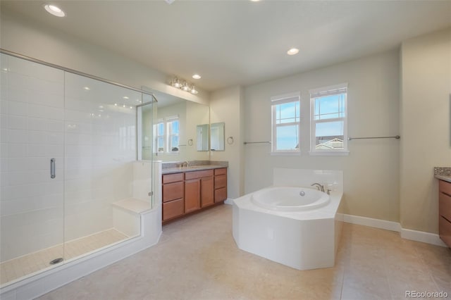 bathroom with vanity, tile patterned floors, and shower with separate bathtub