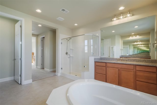 bathroom featuring vanity and independent shower and bath