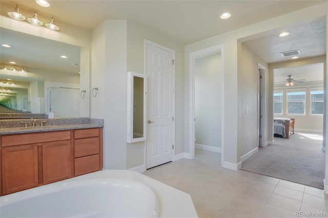 bathroom with vanity, tile patterned floors, ceiling fan, and plus walk in shower