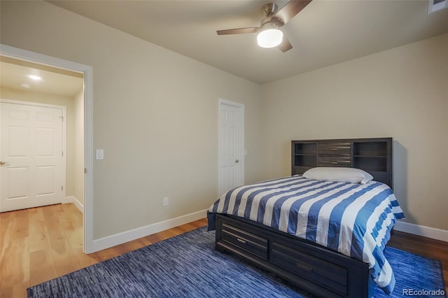 bedroom with hardwood / wood-style floors and ceiling fan