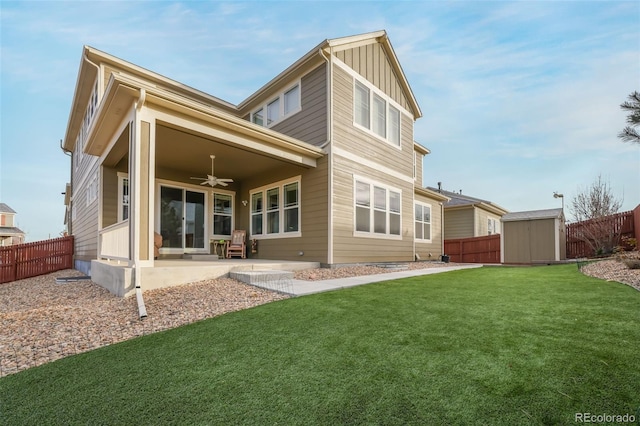 rear view of property with a patio area, a lawn, ceiling fan, and a storage unit