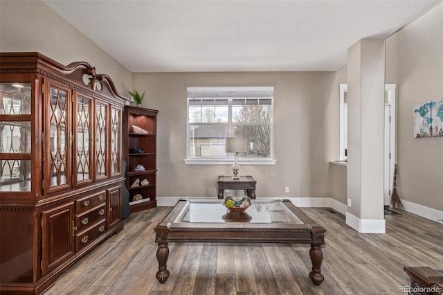 sitting room featuring baseboards and wood finished floors