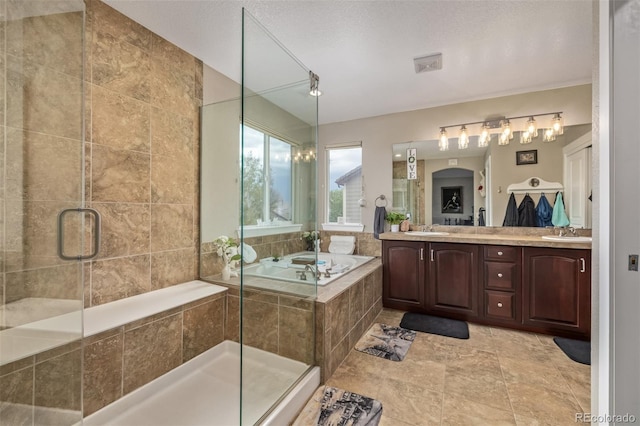 full bath featuring a sink, a shower stall, and a garden tub