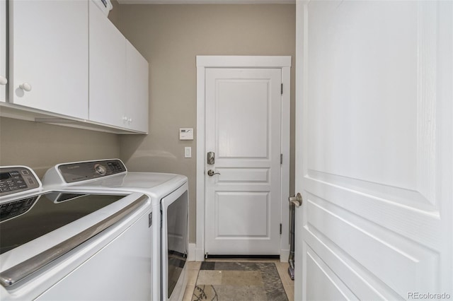 laundry room featuring baseboards, cabinet space, and independent washer and dryer
