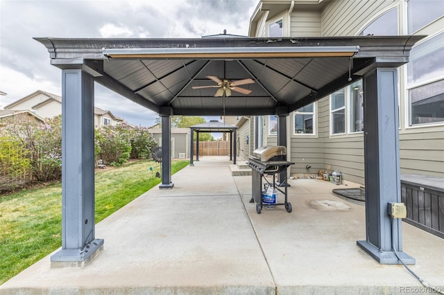 view of patio / terrace featuring fence, a ceiling fan, a gazebo, and grilling area