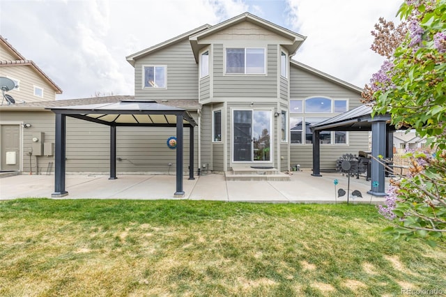 back of house featuring a lawn, a patio, and a gazebo